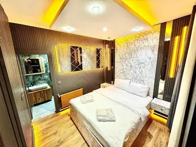 a bedroom with a bed and a large window at Taksim Luxury Arcadia Hotel in Istanbul