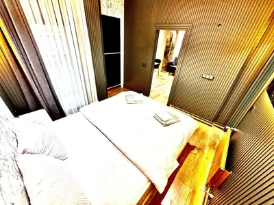 a bedroom with two beds and a mirror at Taksim Luxury Arcadia Hotel in Istanbul