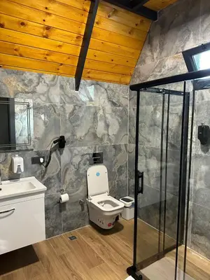 a bathroom with a toilet and a sink at Finymoco in Kartepe