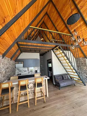 a kitchen with a spiral staircase in a house at Finymoco in Kartepe