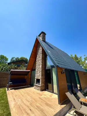 a house with a deck and a brick chimney at Finymoco in Kartepe