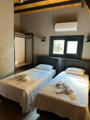 two beds in a room with towels on them at Finymoco in Kartepe