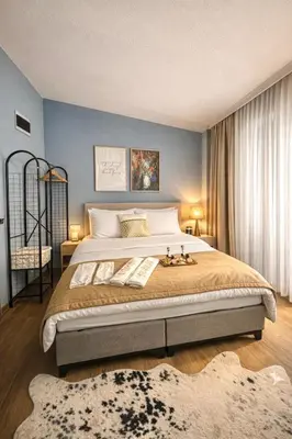 a bedroom with a large bed with blue walls at Casafra in Istanbul