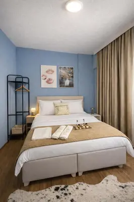 a bedroom with a large bed with blue walls at Casafra in Istanbul