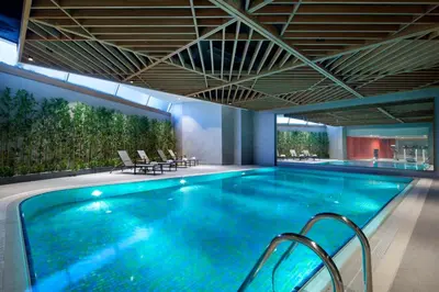 a large swimming pool with blue water in a building at Hilton Garden Inn Istanbul Beylikduzu in Istanbul