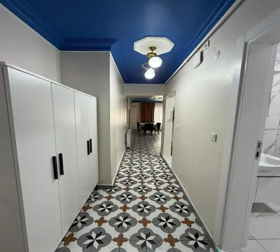 a hallway with a tile floor and a blue ceiling at Armagan Home Taksim in Istanbul