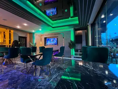 a room with a table and chairs with green lights at Crowned Boutique Hotel in Istanbul