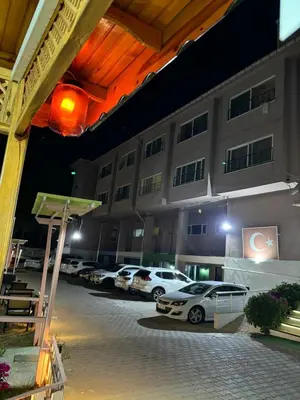 a group of cars parked in front of a building at Kumbağ Otel in Kumbağ