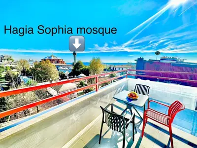 a balcony with two chairs and a table on a roof at Hagia Sophia Palace Hotel in Istanbul