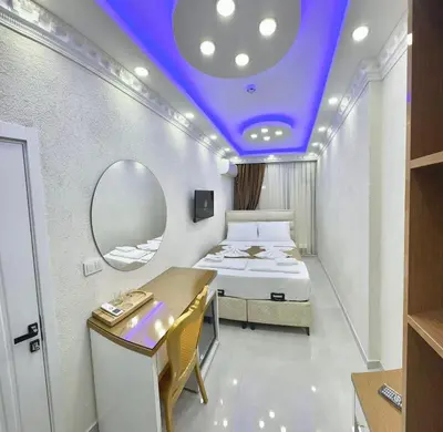 a small room with a bed and a mirror at Hagia Sophia Palace Hotel in Istanbul