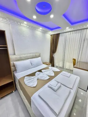 a bedroom with two beds and a blue ceiling at Hagia Sophia Palace Hotel in Istanbul