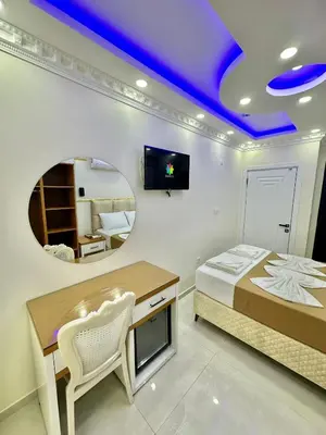 a bedroom with a bed and a table and a mirror at Hagia Sophia Palace Hotel in Istanbul