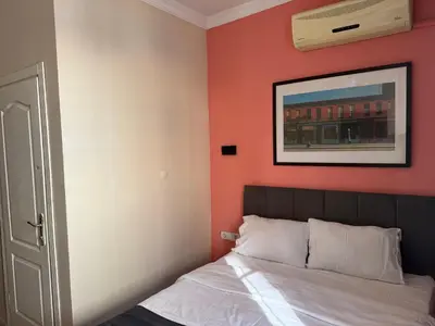 a bedroom with a bed with an orange wall at walkabout apart in Istanbul