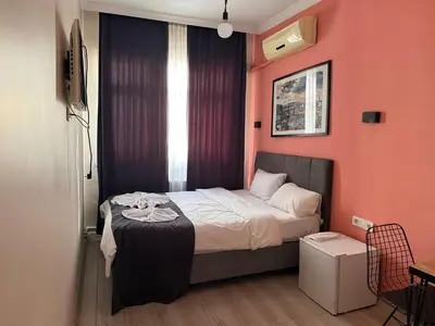 a bedroom with a bed and a window at walkabout apart in Istanbul