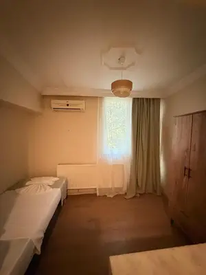 a bedroom with two beds and a window at walkabout apart in Istanbul