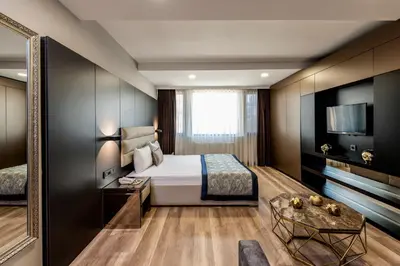 a hotel room with a bed and a television at No 139 Apartments in Istanbul