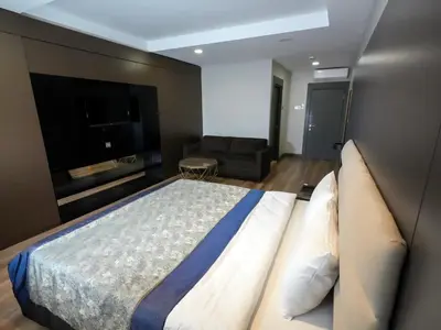 a bedroom with a large bed and a flat screen tv at No 139 Apartments in Istanbul