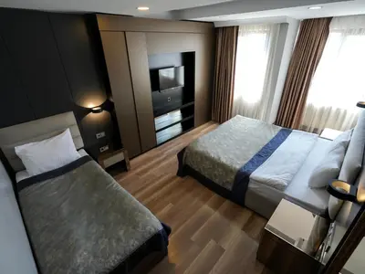 a hotel room with two beds and a television at No 139 Apartments in Istanbul