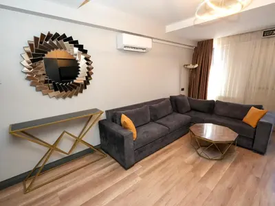 a living room with a couch and a mirror at No 139 Apartments in Istanbul