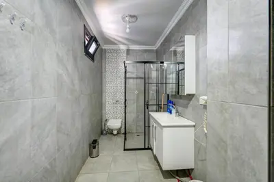 a bathroom with a shower and a toilet and a sink at Par Konaklama in Istanbul