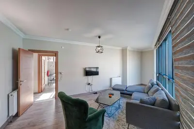 a living room with a blue couch and chairs at Par Konaklama in Istanbul