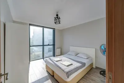 a bedroom with a bed and a large window at Par Konaklama in Istanbul