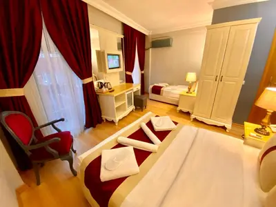 a hotel room with a bed and a desk and a chair at Santefe Hotel in Istanbul