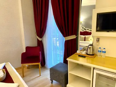 a room with a red curtain and a red chair at Santefe Hotel in Istanbul