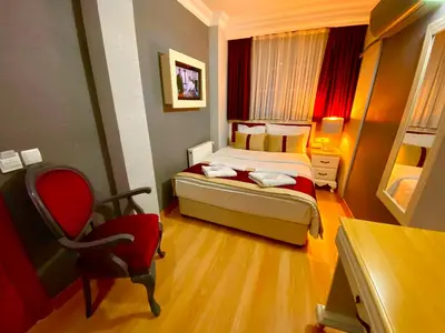 a small room with a bed and a chair in it at Santefe Hotel in Istanbul