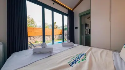 a bedroom with a bed with a large window at The Now Sapanca Suites in Sapanca