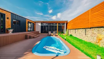a swimming pool on the deck of a house at The Now Sapanca Suites in Sapanca