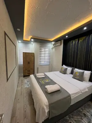 a bedroom with a large bed with towels on it at Poyraz suit in Bursa
