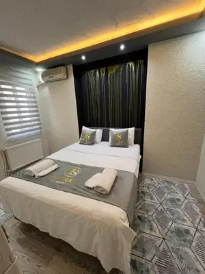 a bedroom with a large bed with towels on it at Poyraz suit in Bursa