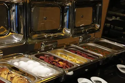 a row of trays of food on a buffet at Istanbul Taksim Pera Star Hotel - Istiklal Street in Istanbul