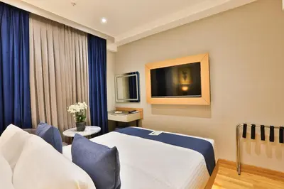 a hotel room with a bed and a tv at Istanbul Taksim Pera Star Hotel - Istiklal Street in Istanbul