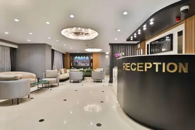 a reception area of a hotel lobby with a reception desk at Istanbul Taksim Pera Star Hotel - Istiklal Street in Istanbul