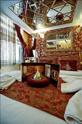 a bedroom with two beds and a mirror at Sultan Suites Hotel in Istanbul