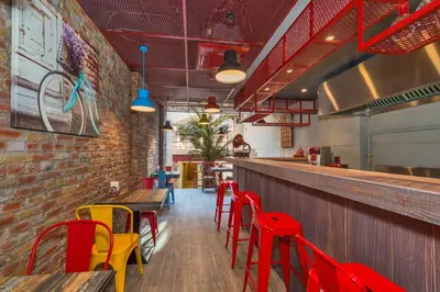 a restaurant with red and yellow chairs and a bar at Taksim Istanbul Nis Hotel - Istiklal Street in Istanbul