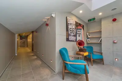 a hallway with two blue chairs and a table at Taksim Istanbul Nis Hotel - Istiklal Street in Istanbul