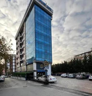a tall blue building with cars parked in a parking lot at 216 Blue Life in Istanbul
