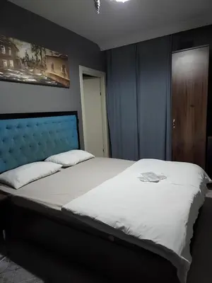 a bedroom with a large bed with a blue headboard at 216 Blue Life in Istanbul