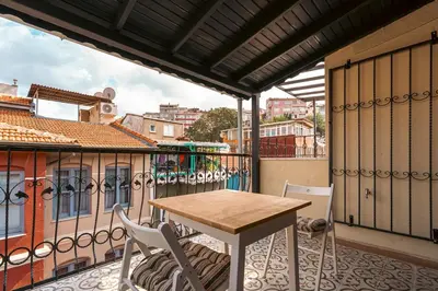 a patio with a table and chairs on a balcony at Mercan Apartments Balat-The Hidden Terrace in Istanbul