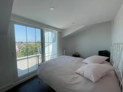 a bedroom with a bed and a large window at Villa Orange in Istanbul