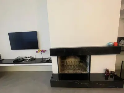 a living room with a fireplace and a television at Villa Orange in Istanbul