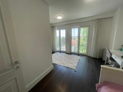 an empty living room with a door and a window at Villa Orange in Istanbul