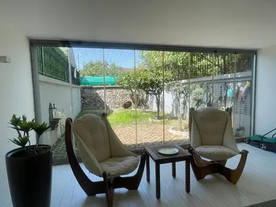 two chairs and a table in a room with a large window at Villa Orange in Istanbul