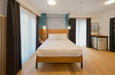 a bedroom with a large bed with white sheets at Pastel İstanbul in Istanbul