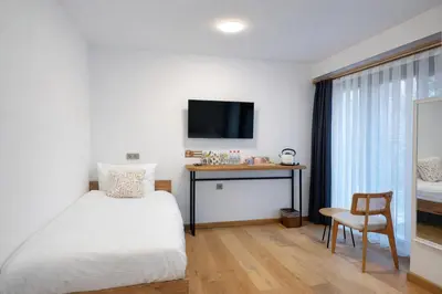 a bedroom with a bed and a desk and a tv at Pastel İstanbul in Istanbul