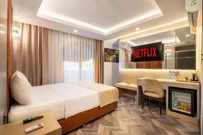 a hotel room with a bed and a desk at 216 Star in Samandra