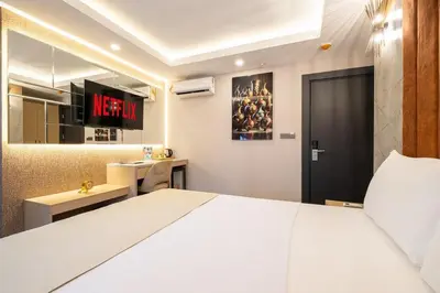 a bedroom with a white bed and a desk at 216 Star in Samandra